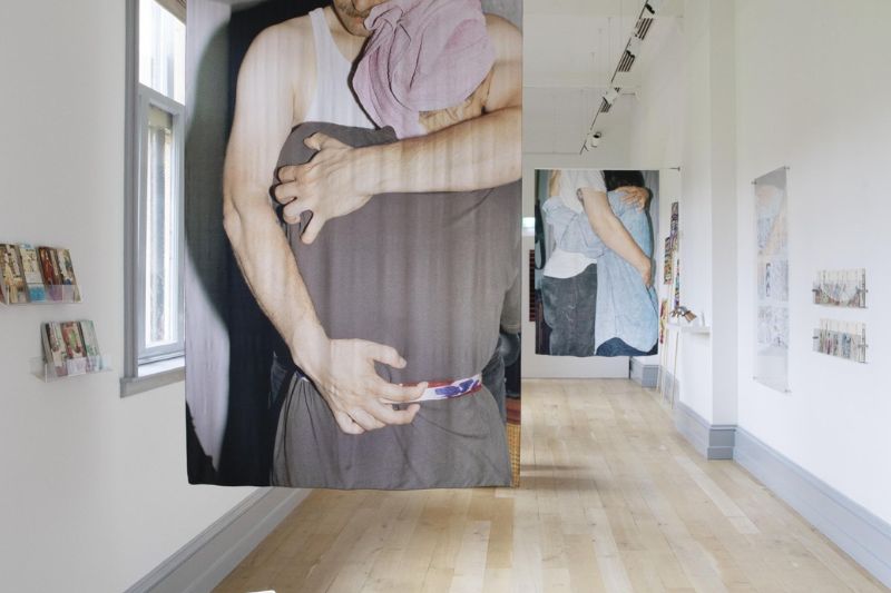 Artworks on display in the naughton galley, a long cream space with grey woodwork